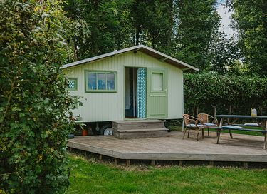 Colorful cottage on wheels at campsite
