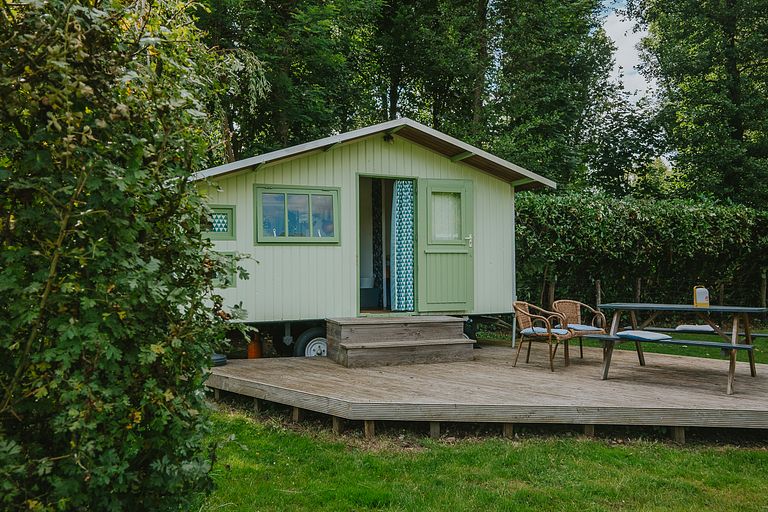 Colorful cottage on wheels at campsite - 1