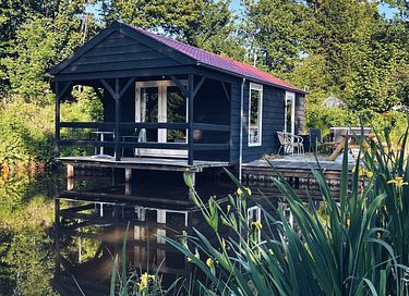 Camping house with veranda on the water