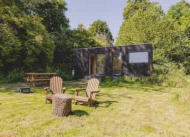 Tiny house in een bos en aan een meer