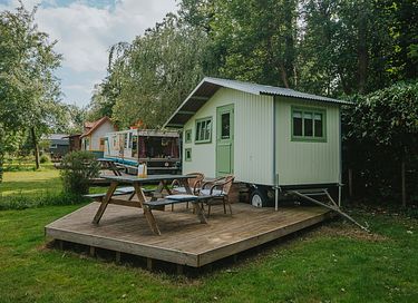 Colorful cottage on wheels at campsite - 8