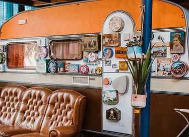 Two-person retro caravan at indoor campsite