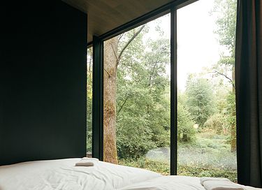 Mirror forest lodge by a stream - 9