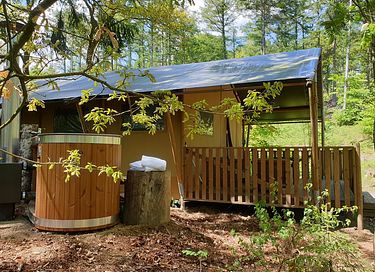Luxury tent in the forest with a hot tub